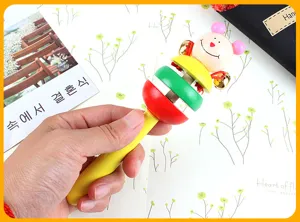 Wooden baby rattle toy with cute animal head, colorful discs and small bells for early education.