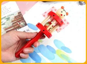 Wooden baby rattle toy with cute cartoon puppet design and clear sound bell for infants.