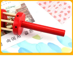 Wooden baby hand rattle toy with red handle and inner bells for infants and toddlers.