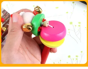 Wooden baby rattle detail shot, colorful cartoon educational toy with bells for early learning.
