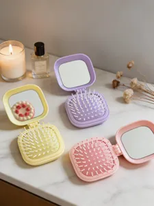 Mini cepillo de pelo plegable con espejo, color caramelo bonito, vista detallada.