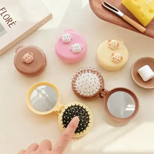 Compact folding hair brush with mirror and cute puppy decoration, portable pocket size.