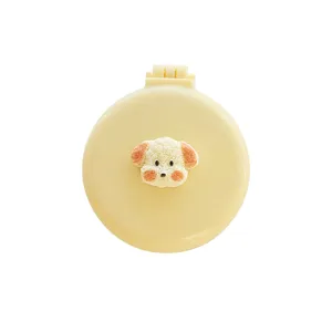 Cute foldable round hairbrush and makeup mirror combo with 3D cartoon puppy design for daily use.