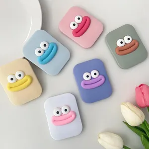 Close-up detail of colorful cute cartoon big mouth folding pocket makeup mirrors.