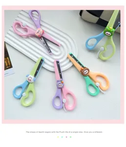 Cute cartoon kids safety scissors detail view, colorful handles with lovely animal charms for DIY.