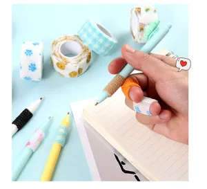 Detailed view of self-adhesive elastic finger bandage rolls and protective wraps on pens.