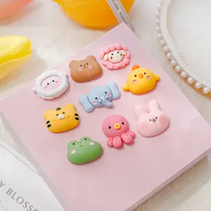 Close-up of cute cartoon animal resin charms, detailed crafting for DIY phone case decor.