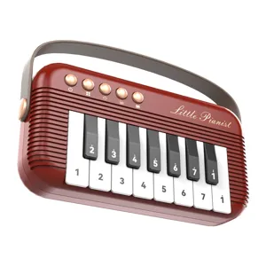 Portable mini toy piano for kids, retro red keyboard with handle and musical keys.