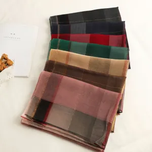 Colorful plaid silk wool scarf detail view, luxurious checkered women shawl and lightweight wrap.