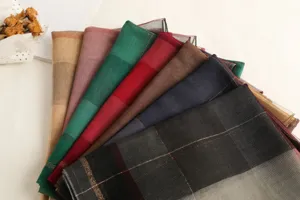 Detailed view of colorful plaid silk wool scarves elegantly arranged in a fan shape.