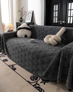 Cozy dark grey fleece sofa cover with embossed paw print design, soft and stylish living room decor.