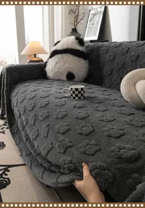 Cozy dark grey plush sofa cover with cute paw print texture, soft flannel furniture protector.