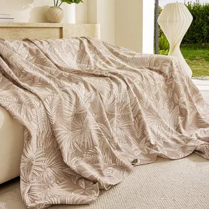 Detailed view of the jacquard sofa cover blanket with elegant tropical leaf pattern for living room