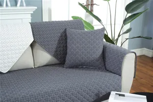 Detail shot of diamond quilted sofa cover, anti-slip fabric cushion protector in dark grey.