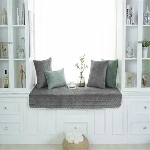 Cojín de terciopelo suave para ventana y cojines decorativos en un hogar luminoso y moderno.