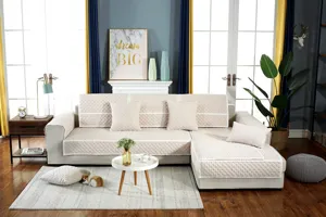 Detailed view of light beige quilted sectional sofa cover set with elegant lace trim design.