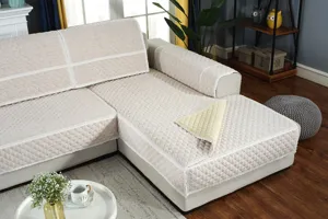 Quilted fabric sofa cover in beige with lace trim, perfect for L-shaped sectional couches.