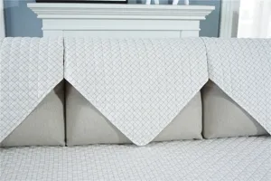 Detailed view of the quilted sofa cover featuring a classic grid pattern for home.