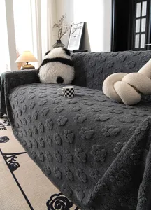 Dark grey plush sofa cover with cute paw print texture, cozy velvet throw for living room.