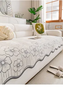 Detail of luxury chenille sofa cushion with elegant floral jacquard and stylish scalloped hem.