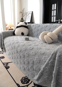 Gray plush sofa cover with cute paw print texture, cozy velvet slipcover detail view for living room.
