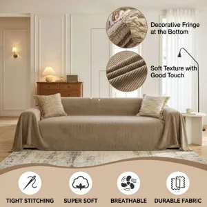 Detailed view of beige chenille sofa cover showing soft corduroy texture and decorative fringe.