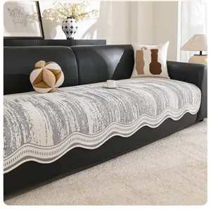 Detailed view of modern luxury chenille sofa cover with grey pattern and wave edge.