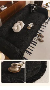 Detailed view of the black chenille sofa cover featuring floral print and elegant fringe design.