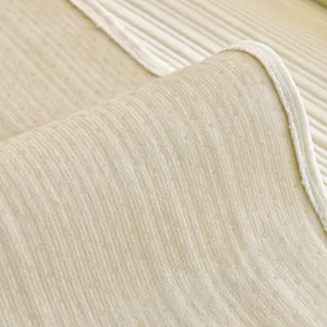 Cream cooling ice silk sofa cover mat with textured doudou dots and non-slip design.