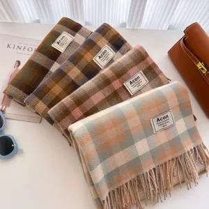 Plaid tassel scarf detail showing soft textured fabric, elegant retro pattern, and cozy winter warmth.