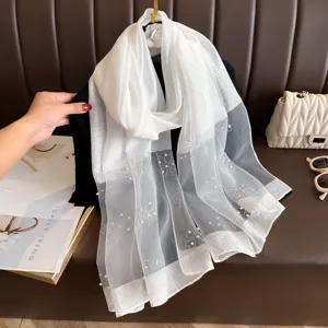 Elegant white polyester long scarf featuring delicate rhinestone and pearl clover embellishments for women.