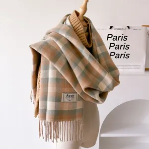 Cozy winter plaid tassel scarf detail, featuring classic checkered pattern and soft warm fabric.