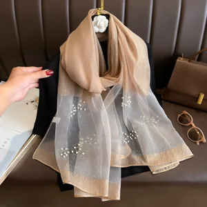 Elegant women's long sheer scarf with pearls, perfect for sun protection and summer styling.