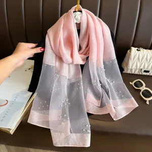 Detail view of the elegant pink rhinestone and pearl embellished sheer long scarf.