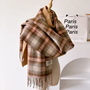 Detailed shot of a vintage plaid fringe scarf in brown and pink, thick warm autumn winter accessory.