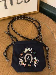Navy blue embroidered drawstring crossbody bag with stylish horse motifs and durable ropes.