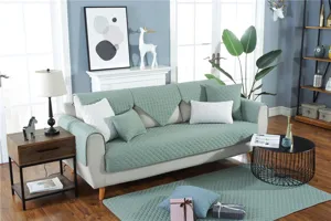 Modern minimalist quilted sofa cover set in solid green cotton, anti-slip fabric for all seasons.