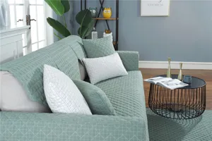 Detail view of modern minimalist quilted sofa cushion cover in soft sage green fabric.