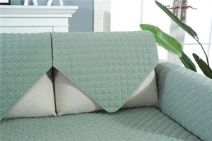 Quilted sofa cover detail showcasing soft fabric texture and modern minimalist design.
