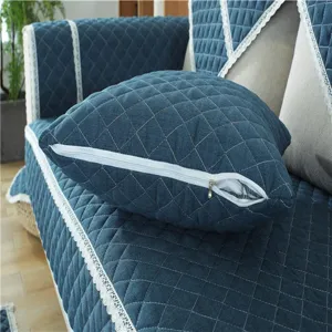 Blue quilted sofa cushion detail, fabric slipcover close up with lace trim and zipper.