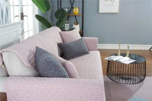 Pink quilted sofa cushion detail view, showing soft fabric texture and elegant home decor setup.
