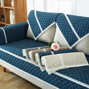 Quilted sofa cushion set with delicate lace trim, solid blue design for living room decor.
