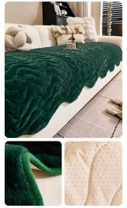 Close-up detail of dark green plush sofa cover showing wave edge and anti-slip backing.