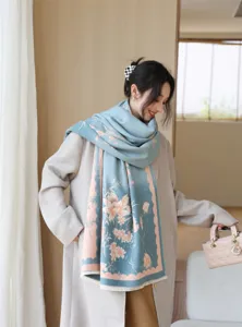 Detailed view of the elegant blue winter scarf featuring delicate floral patterns and soft fabric.
