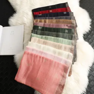 Multi-color silk wool blend scarf with golden grid design, elegant fashion shawl detail.