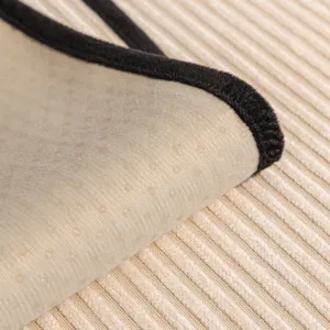 Non-slip sofa cushion cover fabric close up, durable backing and black edge trim for daily use.