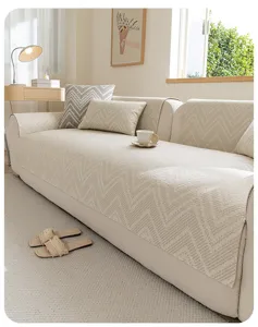 Detailed view of beige linen-style sofa cover showcasing textured chevron pattern fabric.