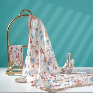 Delicate floral print silk scarf detail, elegant lightweight fabric with botanical pattern.