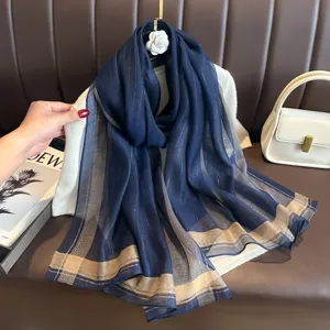 Elegant navy blue long silk scarf with metallic gold stripes, perfect for autumn and winter.