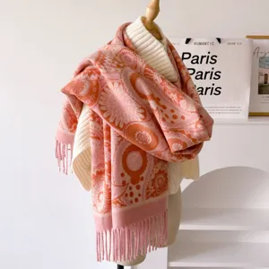 Detail shot of women's pink paisley jacquard scarf shawl, soft warm winter neck wrap accessory.